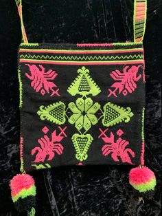 "Stunning double woven Huichol bag/morral with a traditional design in hot pink and neon yellow on a black background.  The design is identical on both sides and because it is double woven, the inside is mostly pink. The bag is 13\" x 13\" with a 22\" long x 1 1/4\" wide strap in matching colors There are large pompoms coming off the bottom corners. This bag is so beautiful! The items on this site were inherited from a family member.  They are from a 35 year collection of very high quality coinage pieces which were gifted in gratitude for large donations. We would like to see these unique items worn an appreciated.  We hope you will enjoy their beauty and craftsmanship." Deer Design, Woven Bag, Butterfly Wings, Teal Green, Neon Yellow, In Hot, Traditional Design, Pink Yellow, Black Background