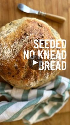 a loaf of no knead bread sitting on top of a blue and white towel