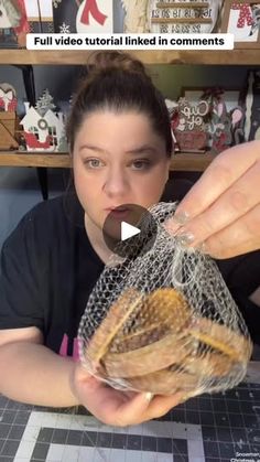 a woman is holding a bag full of cookies in front of her face and the caption reads, full video tutorial linked in comments