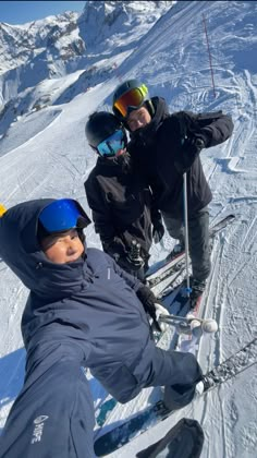 two people on skis posing for the camera