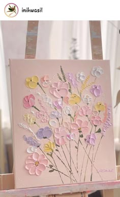 an easel with flowers painted on it