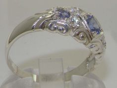 "*This ring is made from 925 Sterling Silver with Natural Tanzanite and 0.08 carats Diammond. This Beautiful Unusual Solid Silver Ring has been hand set with a stunning selection of Natural Tanzanites and Sparkling Diamond. The round cut Tanzanites measures 4.5mm (0.18\") and 2.25mm (0.09\"), and the Diamond also measures 2.25mm (0.09\") round. Being Natural each Tanzanite is Unique and has been specifically selected for this ring to ensure a good match of color and quality by expert Jewellers. Pretty Wedding Rings, Magical Jewelry, Dope Jewelry, Sparkling Diamond, Silver Wedding Rings, Jewelry Lookbook, Natural Tanzanite, Cute Rings, Pretty Rings