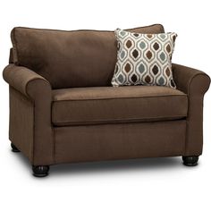 a brown couch with two pillows on the armrests and one pillow sitting on top of it