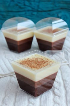 three desserts sitting on top of a white cloth