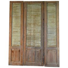 two wooden doors with blinds on them