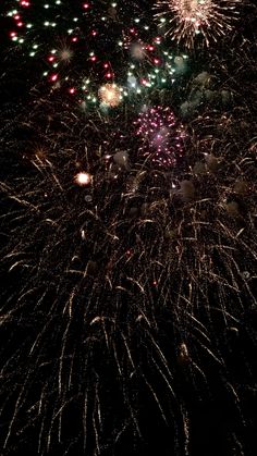 fireworks are lit up in the night sky