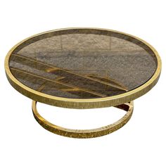 a round glass table with gold trim around it