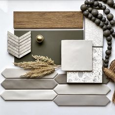 a white table topped with lots of different types of tiles and wood pieces on top of each other