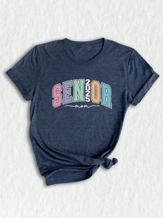 Get ready to celebrate the graduating class of 2025 with this trendy and stylish Senior 2025 T-shirt!  Designed specifically as a thoughtful graduation gift, this tee is perfect for seniors, college students, and anyone looking to commemorate this special milestone in style. Featuring a unique design that combines all the key elements of a truly memorable senior year, this shirt is a must-have for anyone in the class of 2025. ✨ The eye-catching graphic showcases the words "Senior 2025" in bold, School Spirit Shirt With Letter Print For College Events, School Spirit Shirt With Graphic Print For College Events, Graduation T-shirt With Letter Print In Relaxed Fit, Graphic Print Shirt For College Events, Short Sleeve T-shirt With Text Print For Graduation, Graphic Tee Tops With Graphic Print For Graduation, Short Sleeve Letter Print T-shirt, Casual Short Sleeve T-shirt For Graduation Gift, Casual Crew Neck Top For Graduation Gift