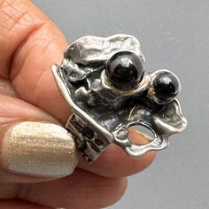 Massive  ~ Vintage ~ Mod / modern Brutalist ~ sterling silver  statement ring . Signed 925 with some faded initials (probably makers mark )  Material :  sterling silver onyx glass  beads Dimensions :  its open at the end so can be adjusted a bit according to ring size as is is 7 1/2 - 8  Top is approx. 1  inches x 5/8 inches wide . weighs 13 grams on my weighing scale  . Condition : Good vintage condition with some minor age related wear .  Please Note ~ As vintage items are previously loved /used please do expect some minor wear like surface wear /dents /dings and metal discoloration . All items are carefully inspected and major flaws will be listed separately ~ Plenty of photograph are added so please study the photos carefully as it is also part of description or if you need more pictur Statement Ring Silver, Ring Vintage, Statement Ring, Makers Mark, Handcrafted Jewelry, Statement Rings, Onyx, Glass Beads, Initials