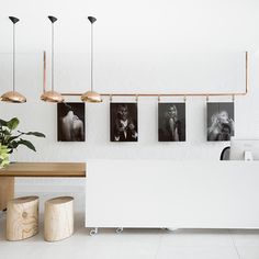 the interior of a restaurant with plants and pictures on the wall