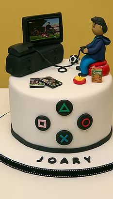 there is a cake that looks like it has a video game controller on top of it