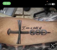 a cross with the words i am a child of god tattooed on it's arm