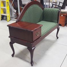 a green and brown chair sitting on top of a white floor