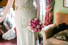 a woman in a white dress holding a bouquet of flowers