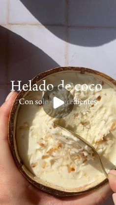 someone is holding a bowl of ice cream with a spoon in it and the text reads, helado de coco consol