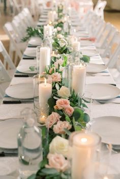 a long table with candles and flowers on it is set for an elegant dinner party