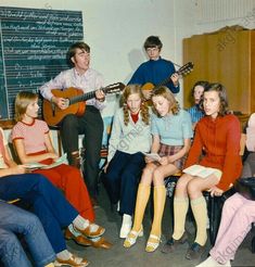 a group of young people sitting next to each other