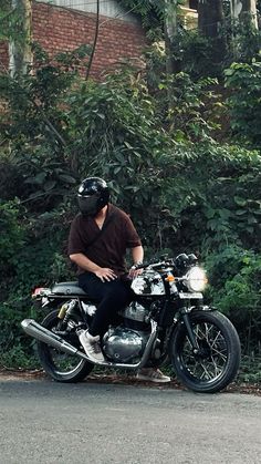 a man wearing a helmet sitting on a motorcycle