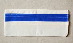 the blue and white striped fabric is folded on top of an empty piece of cloth