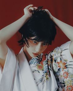 a woman with black hair wearing a kimono