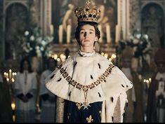 a man wearing a crown and gown in a church