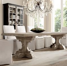 a dining room table with white chairs around it