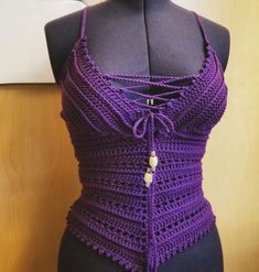 a purple crocheted halter top on a mannequin