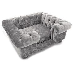 a gray couch sitting on top of a white floor