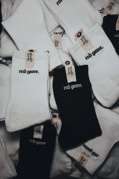 five pairs of socks with the words end game printed on them and tags attached to them