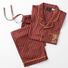 two pieces of red and yellow striped pajamas on a white background, one with an orange stripe