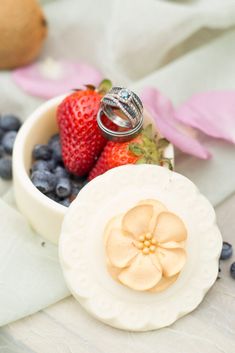 a small white bowl filled with fruit on top of a table