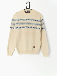 80s vintage Eisbär wool jumper in beige and blue, made in Austria. This jumper features a crew neck and an Eisbär embroidered logo on the bottom left of the jumper. Made in Austria from a heavy weight coarse wool, this jumper is ideal for staying toasty warm in the winter months. Our recommended size: Medium Label says: Medium to large Condition: Very good  Material: 100% pure new wool Measurements in inches: Pit to pit: 20 Shoulders: 18 Front length: 27.5 Back length: 27 Sleeve length: 25.5 Hem Cozy Beige Crew Neck Sweater, Cream Crew Neck Sweater For Winter, Retro Cotton Beige Sweater, Retro Beige Cotton Sweater, Cream Wool Sweater With Fair Isle Pattern, Cream Retro Winter Sweater, Retro Crew Neck Cream Sweater, Retro Cream Crew Neck Sweater, Vintage Beige Cotton Sweater