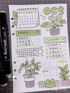 an open planner with plants on it next to a pen