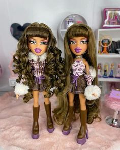 two dolls are standing next to each other