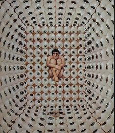 an image of a man sitting in the middle of a circle with eyes all around him