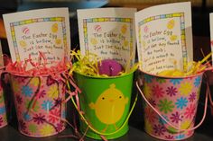 four buckets filled with easter eggs on top of a table