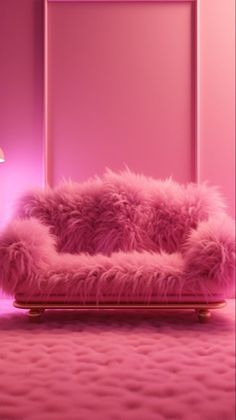 a pink couch sitting on top of a bed next to a lamp