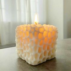 a lit candle sitting on top of a table