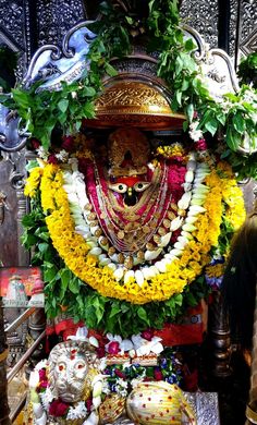 an idol is adorned with flowers and garlands