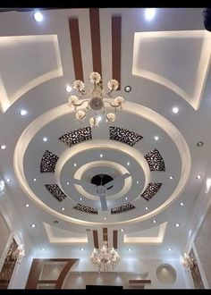 the ceiling is decorated with chandeliers and lights in an elegant style, it looks to be painted white