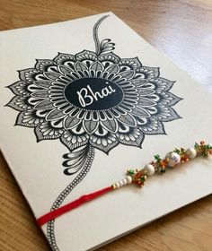 a greeting card with the word bhaj written on it and beaded tassels