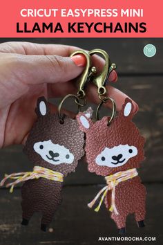 two llama keychains are being held by someone's hand with the text cricut easypress mini llama key chains