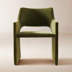 a green chair sitting on top of a white floor