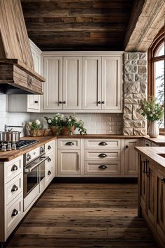 a kitchen with wooden floors and white cabinets, wood flooring, and stone walls