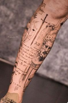 a man's leg with a cross on it and some writing all over it