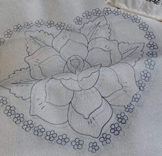 an embroidered piece of cloth with a flower on it