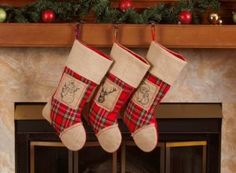 two christmas stockings hanging from a mantel