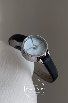 This sleek watch features a round blue dial and a comfortable black genuine leather strap, offering simplicity and style. Its minimalist design is perfect for any occasion, effortlessly complementing a variety of looks. Timeless Black Watch With Round Dial, Affordable Modern Black Watches, Minimalist Black Watch With Features, Black Minimalist Watch With Rectangular Dial, Elegant Blue Analog Watch, Sleek Watch, Round Leather, Elegant Gift, Minimalist Fashion