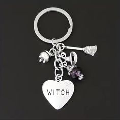 a heart shaped keychain with charms attached to it that says,'witch '